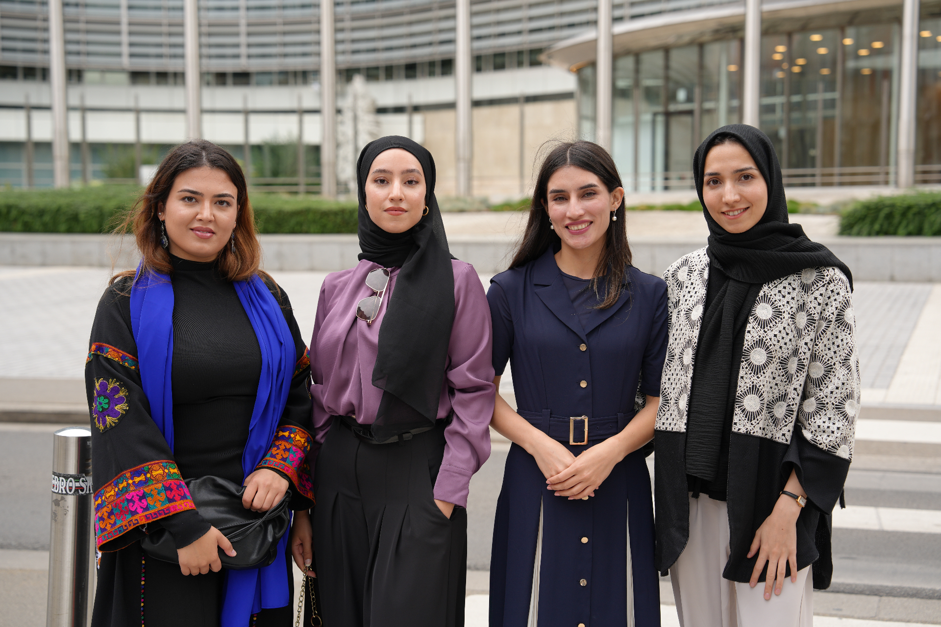 Four young Afghan women participating in international civic engagement